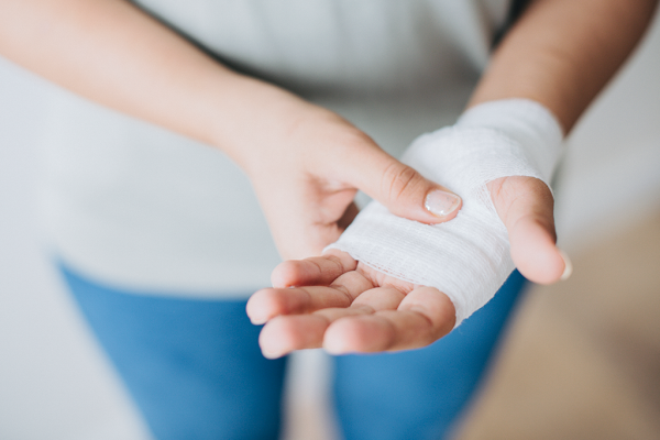 woman-with-gauze-bandage-wrapped-around-her-hand